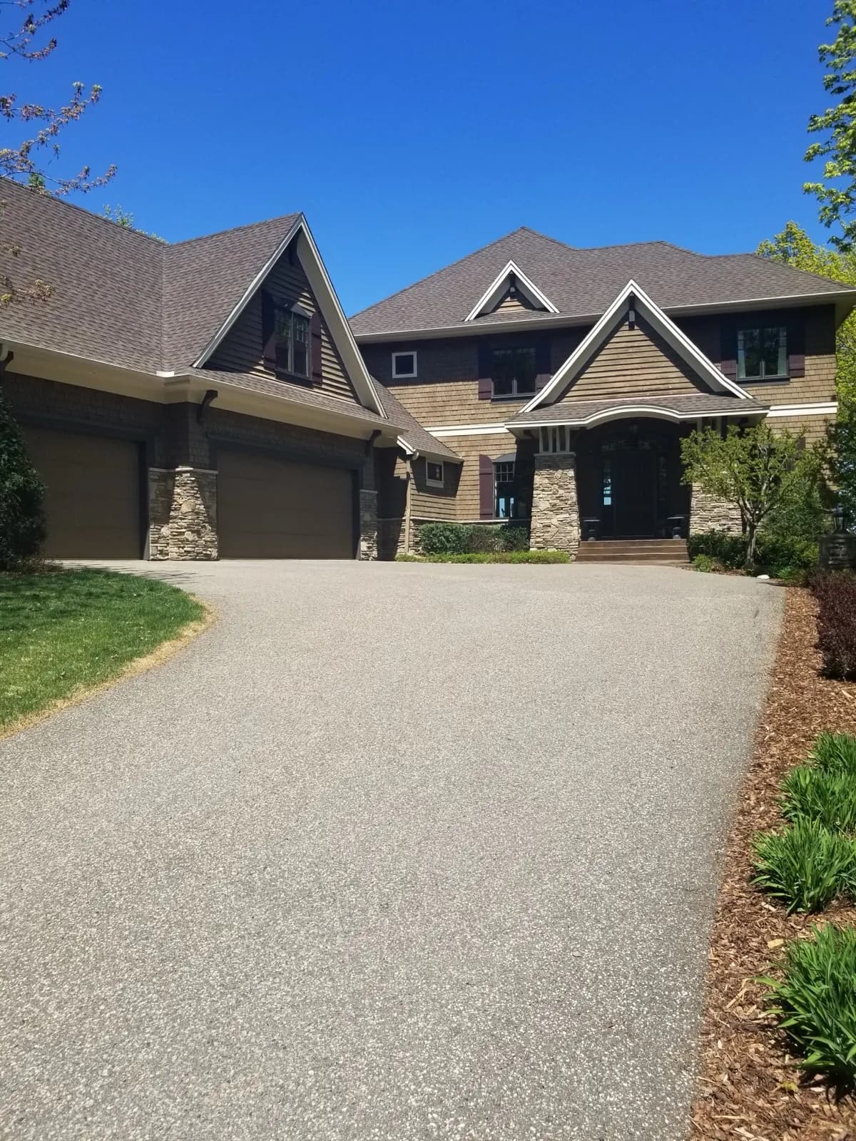 Full exterior: roofing, siding, stone, and landscaping on a Midwest home